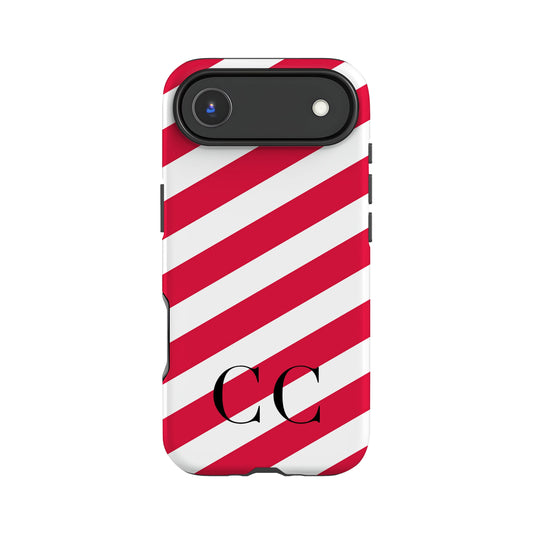 a phone case with a red and white striped pattern and a camera lens attached to the top.